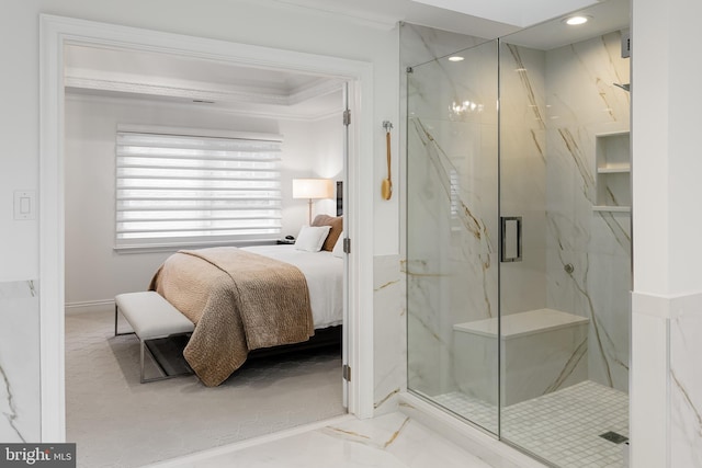 bathroom with a shower with shower door and crown molding