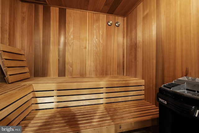 view of sauna / steam room with wood ceiling and wooden walls