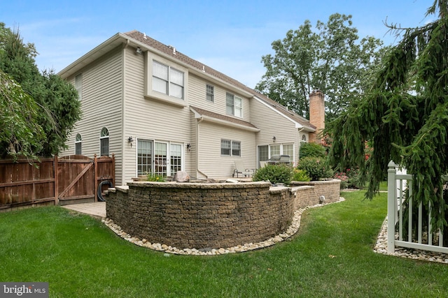 rear view of house with a yard