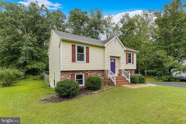 raised ranch with a front yard