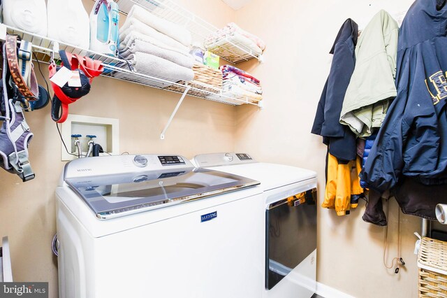 clothes washing area with washer and dryer