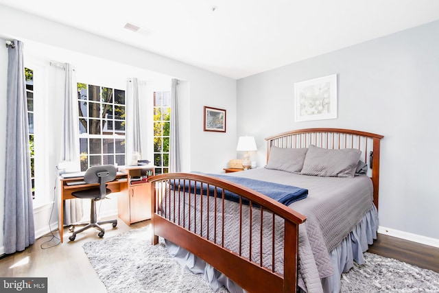 bedroom with hardwood / wood-style flooring