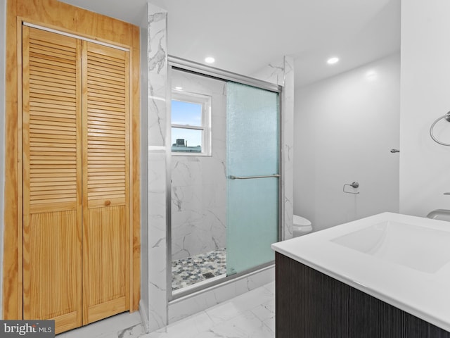 bathroom with vanity, toilet, and an enclosed shower