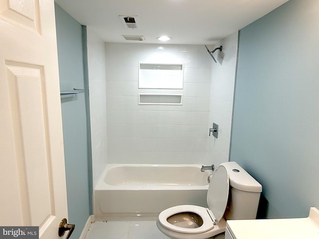 full bathroom featuring tiled shower / bath, vanity, and toilet