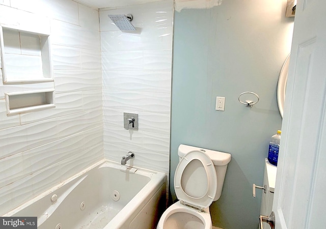 bathroom featuring tiled shower / bath and toilet