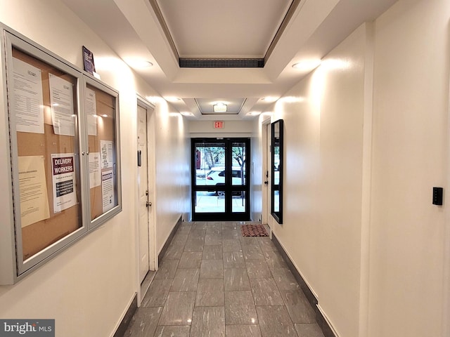 hallway with a tray ceiling