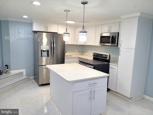 kitchen with white cabinets, pendant lighting, stainless steel appliances, a center island, and ornamental molding