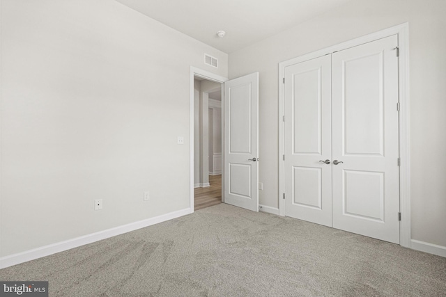 unfurnished bedroom featuring a closet and carpet