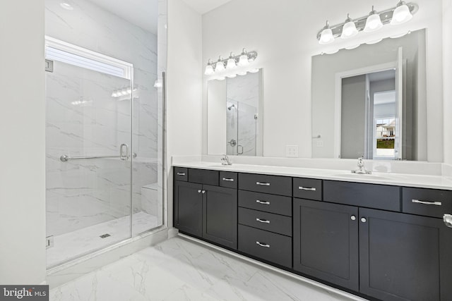 bathroom featuring a shower with shower door and vanity