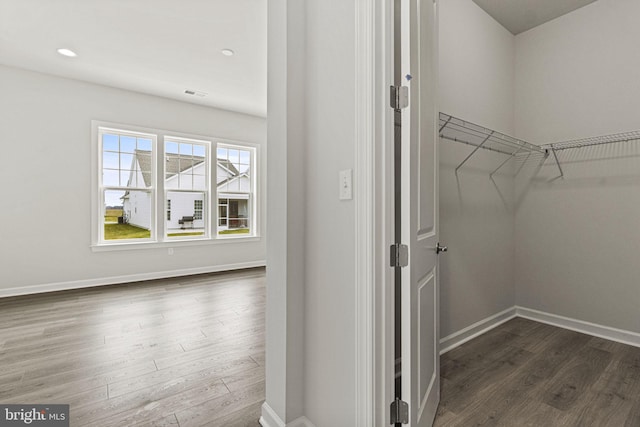 walk in closet featuring dark wood-type flooring