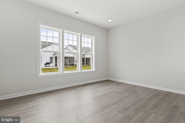 spare room featuring light hardwood / wood-style flooring