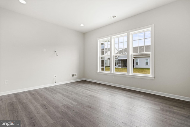 unfurnished room with hardwood / wood-style floors