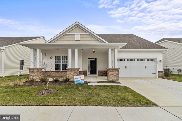 craftsman-style house with a porch, a garage, and a front lawn