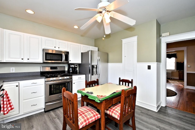 kitchen featuring white cabinetry, dark hardwood / wood-style floors, stainless steel appliances, and ceiling fan