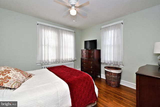 bedroom with radiator, dark wood-type flooring, and ceiling fan