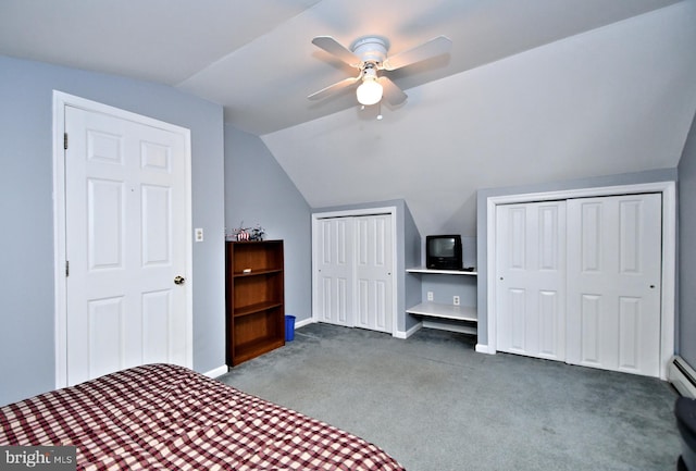 unfurnished bedroom featuring carpet, lofted ceiling, ceiling fan, and multiple closets