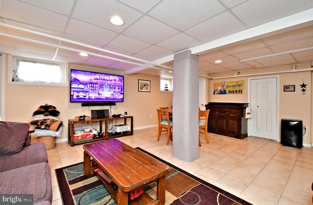 tiled living room featuring a paneled ceiling