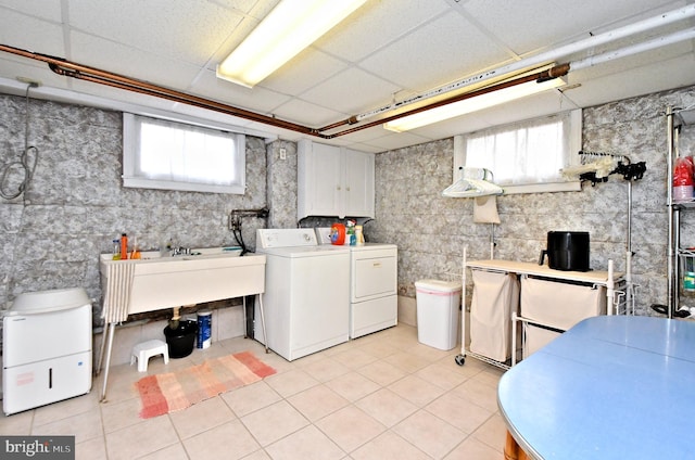 laundry room featuring sink, cabinets, washing machine and clothes dryer, and light tile patterned floors