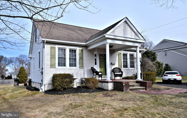 view of front facade with a front yard and a porch