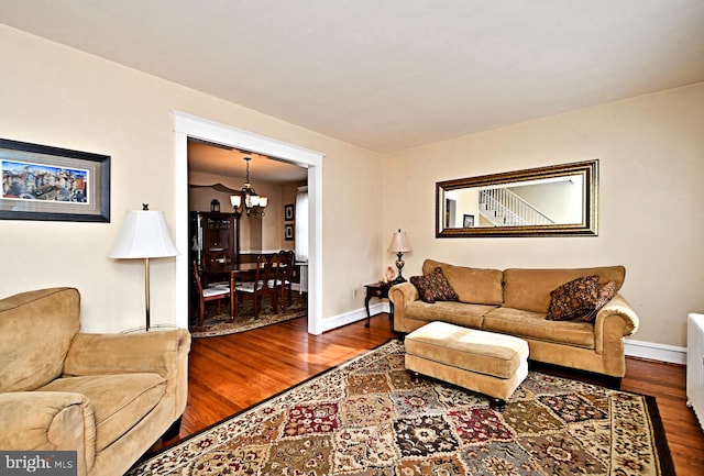 living room with a notable chandelier and hardwood / wood-style floors