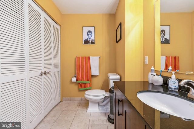 bathroom featuring tile patterned flooring, toilet, and sink