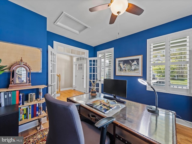 office featuring hardwood / wood-style floors, ceiling fan, and french doors