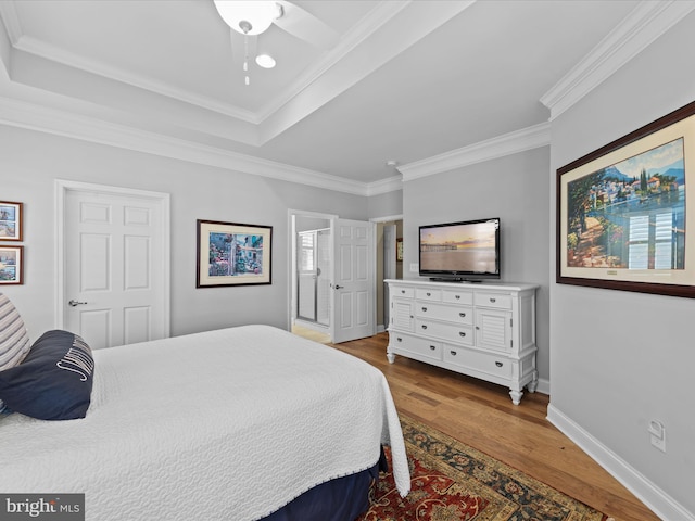 bedroom with ornamental molding, ceiling fan, and light hardwood / wood-style flooring