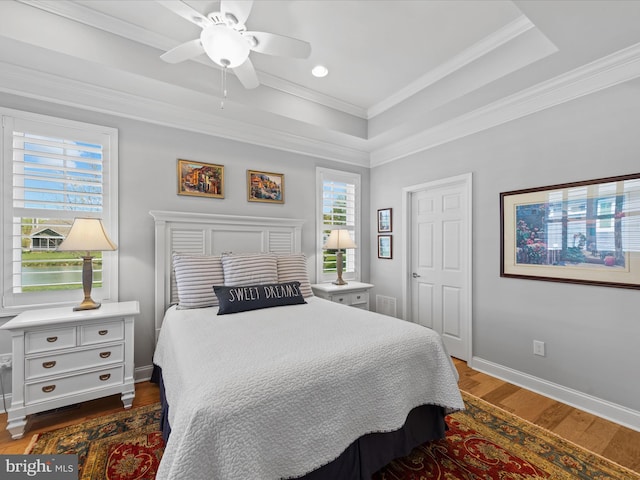 bedroom with ceiling fan, crown molding, and dark wood-type flooring