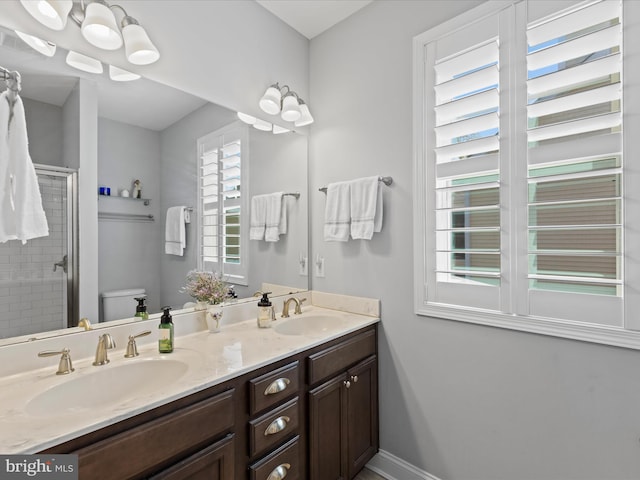 bathroom featuring walk in shower, vanity, and toilet