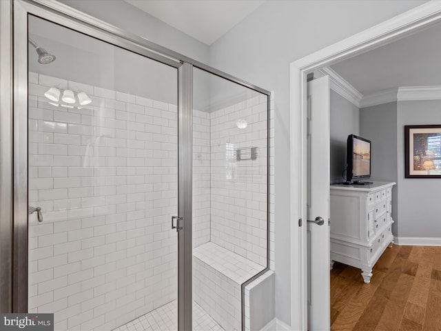 bathroom featuring ornamental molding, vanity, an enclosed shower, and hardwood / wood-style floors