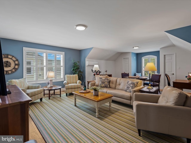 living room featuring lofted ceiling