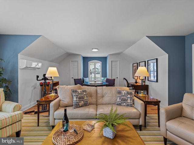 living room with lofted ceiling and a wall mounted AC