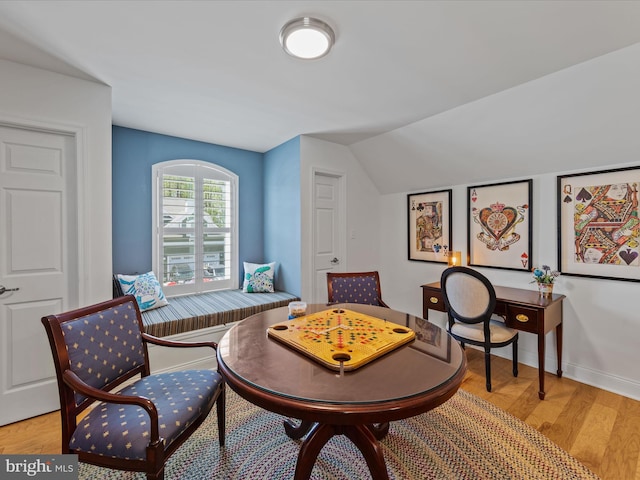 interior space with light hardwood / wood-style flooring and vaulted ceiling