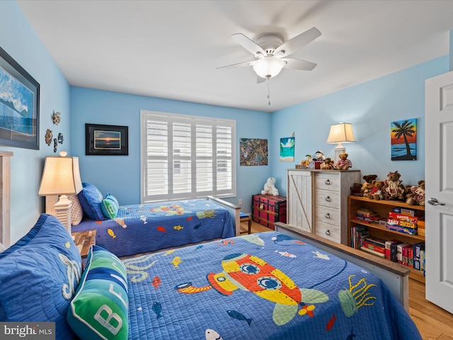 bedroom with wood-type flooring and ceiling fan