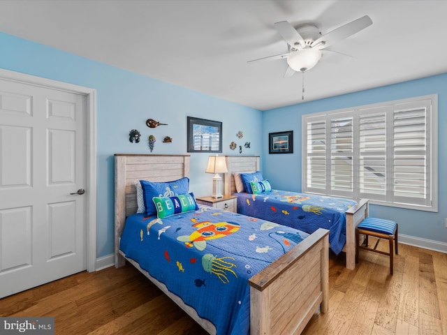 bedroom with ceiling fan and hardwood / wood-style flooring