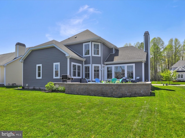 back of house with a lawn and a patio area