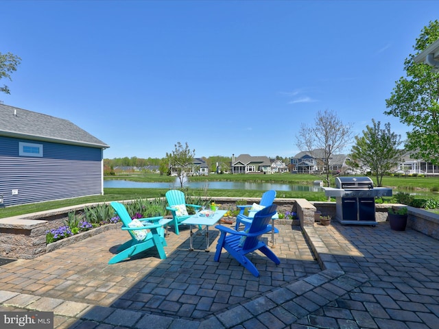 view of patio / terrace with a water view and area for grilling