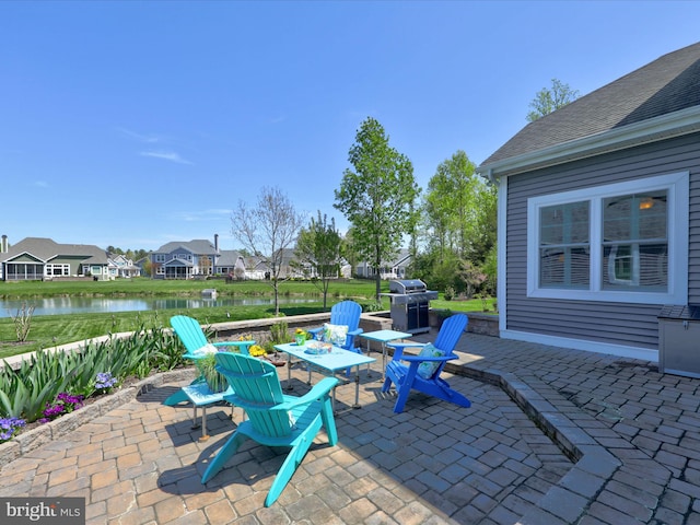 view of patio / terrace with a water view and grilling area