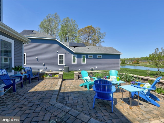 view of patio / terrace featuring a water view and a fire pit