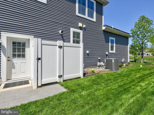 exterior space with cooling unit and a yard