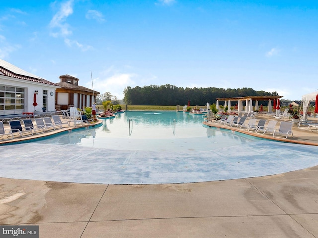 view of swimming pool with a patio area