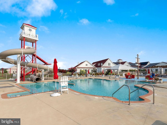 view of pool featuring a patio and a water slide