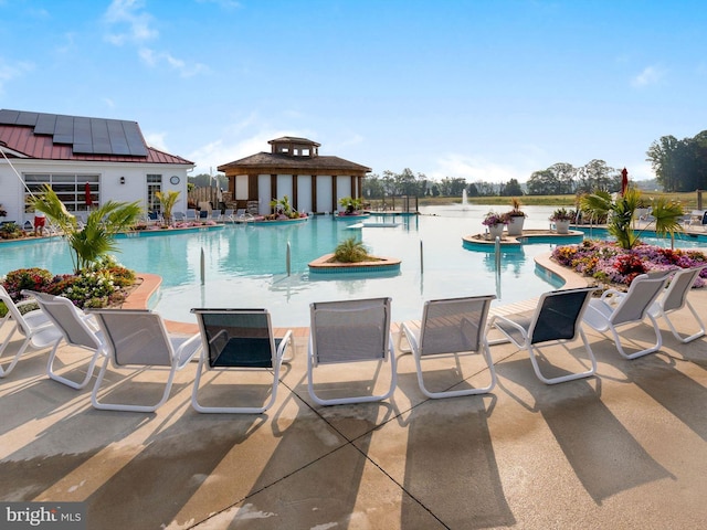 view of pool featuring a patio area and an outbuilding