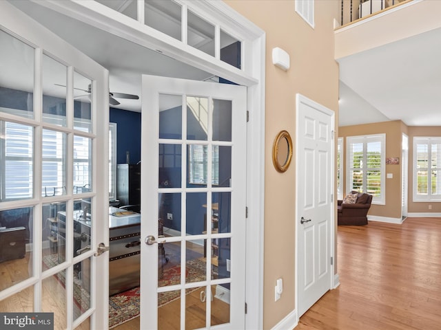 room details featuring french doors, wood-type flooring, and ceiling fan