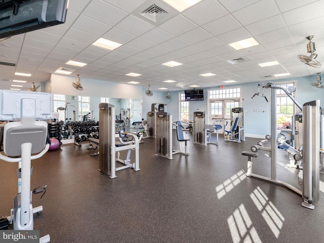 exercise room featuring a drop ceiling