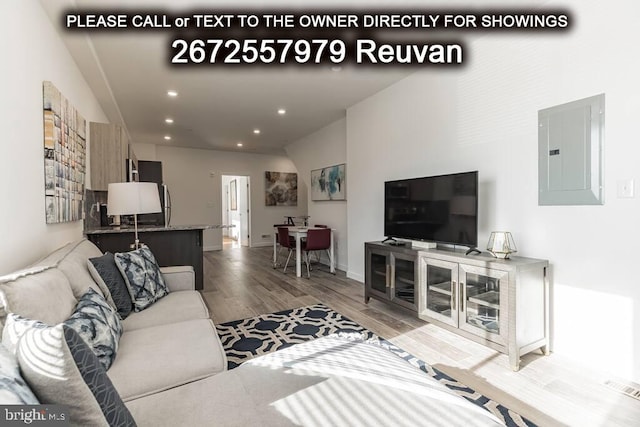 living room featuring electric panel and hardwood / wood-style floors