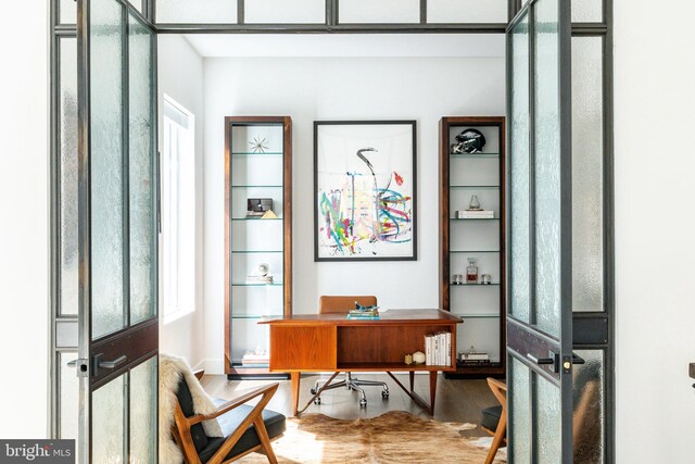 interior space with light wood-type flooring and french doors