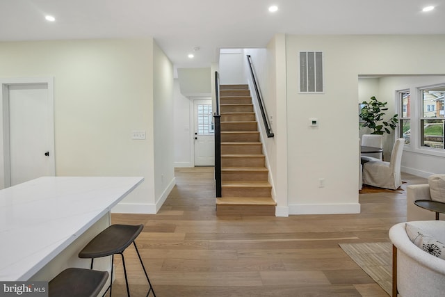 staircase with hardwood / wood-style flooring