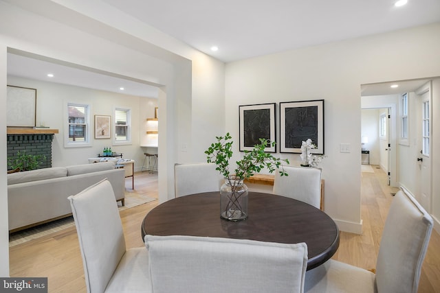 dining space with light wood-type flooring and a wealth of natural light