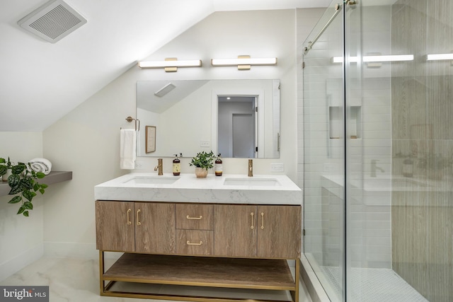 bathroom featuring a shower with door, vanity, and vaulted ceiling